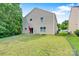 View of the home's backyard with a patio seating area, green lawn, and mature trees at 5311 Oakdale Ridge Rd, Charlotte, NC 28216