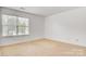This is a bright bedroom with a window and carpet flooring at 5311 Oakdale Ridge Rd, Charlotte, NC 28216