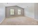 A large bedroom with neutral walls, vaulted ceilings, and two bright windows at 5311 Oakdale Ridge Rd, Charlotte, NC 28216
