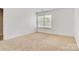 The bright bedroom has carpet flooring and a window for natural light at 5311 Oakdale Ridge Rd, Charlotte, NC 28216