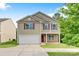 Charming two-story home with a well-maintained lawn, two car garage and classic curb appeal at 5311 Oakdale Ridge Rd, Charlotte, NC 28216