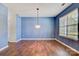 Living room with new flooring, modern chandelier, and a bright window letting in natural light at 5311 Oakdale Ridge Rd, Charlotte, NC 28216