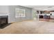 Open living room featuring a fireplace, large windows, and hardwood floors at 5311 Oakdale Ridge Rd, Charlotte, NC 28216