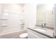 Well-lit bathroom with a shower-tub combo, toilet, and a modern sink with countertop space at 617 English St, Monroe, NC 28110