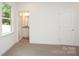 An airy bedroom looking into the on-suite bath, with plush carpeting, and neutral paint at 617 English St, Monroe, NC 28110