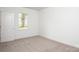 Bright bedroom with one window, plush carpeting, and neutral paint throughout at 617 English St, Monroe, NC 28110