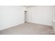 A simple, cozy bedroom with plush carpeting, and neutral paint throughout at 617 English St, Monroe, NC 28110