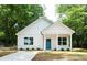 Beautifully renovated one-story home with a bright blue front door and neatly landscaped front yard at 617 English St, Monroe, NC 28110