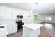 Bright, modern kitchen featuring white cabinets, stainless steel appliances, and a stylish island for food preparation at 617 English St, Monroe, NC 28110