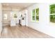 Bright, modern kitchen with white cabinets, stainless steel appliances, and an open layout flows into living area at 617 English St, Monroe, NC 28110