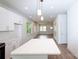 Bright open-concept with white walls, wood flooring, and a quartz-topped kitchen island at 617 English St, Monroe, NC 28110