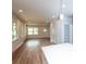 Bright open-concept with white walls, wood flooring, and a quartz-topped kitchen island at 617 English St, Monroe, NC 28110