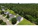 Aerial shot of a house featuring a green lawn and backing up to a large wooded area at 6229 Sid Crane Dr, Charlotte, NC 28216