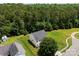 Aerial view of a home with an expansive green lawn and surrounding trees at 6229 Sid Crane Dr, Charlotte, NC 28216