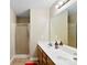 Bathroom featuring tiled shower, double sinks and white vanity with large mirror at 6229 Sid Crane Dr, Charlotte, NC 28216