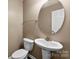 Clean and modern half-bathroom with a pedestal sink and ample lighting at 6229 Sid Crane Dr, Charlotte, NC 28216