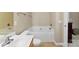 Bathroom with a toilet, large soaking tub, a sink with a chrome faucet and mirror at 6229 Sid Crane Dr, Charlotte, NC 28216