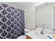 Cozy bathroom with patterned shower curtain, toilet, and sink at 6229 Sid Crane Dr, Charlotte, NC 28216
