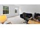 Bright bedroom featuring two large windows providing natural light and a cozy sitting area at 6229 Sid Crane Dr, Charlotte, NC 28216