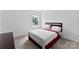 Bright bedroom features carpet, a window, and a bed with a white and red quilt at 6229 Sid Crane Dr, Charlotte, NC 28216