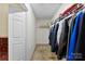 Walk-in closet with hanging clothes, shelving and carpeted flooring at 6229 Sid Crane Dr, Charlotte, NC 28216
