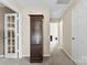 Hallway boasts carpet flooring, access to other rooms, and a decorative curio cabinet at 6229 Sid Crane Dr, Charlotte, NC 28216
