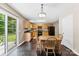 Bright kitchen featuring wooden cabinetry, black appliances, and an adjacent dining area at 6229 Sid Crane Dr, Charlotte, NC 28216