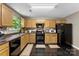 Functional kitchen featuring wooden cabinets, black appliances, and durable countertops at 6229 Sid Crane Dr, Charlotte, NC 28216