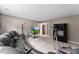 Large, comfortable seating and media in this spacious room with natural light at 6229 Sid Crane Dr, Charlotte, NC 28216