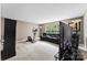 Expansive living room with multiple seating areas, exercise equipment, and ample natural light at 6229 Sid Crane Dr, Charlotte, NC 28216
