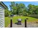 Spacious backyard featuring a well-maintained lawn, mature trees, and a grill for outdoor entertaining at 6718 Pueblo Ln, Charlotte, NC 28227
