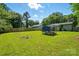 Large backyard featuring a lush green lawn, mature trees, and a fence for privacy and security at 6718 Pueblo Ln, Charlotte, NC 28227