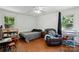 A bedroom with wood floors, two windows, a recliner, and a crib at 6718 Pueblo Ln, Charlotte, NC 28227