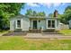 Charming single story home with a chimney, green yard and landscaped front at 6718 Pueblo Ln, Charlotte, NC 28227