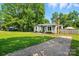 Single story house with a well-manicured lawn and long driveway at 6718 Pueblo Ln, Charlotte, NC 28227