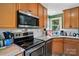 A well-appointed kitchen with stainless steel appliances, granite countertops, and wood cabinetry at 6718 Pueblo Ln, Charlotte, NC 28227