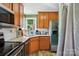 A well-lit kitchen with stainless steel appliances, granite countertops, and wood cabinetry at 6718 Pueblo Ln, Charlotte, NC 28227