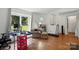Cozy living room with hardwood floors, a large window and neutral decor at 6718 Pueblo Ln, Charlotte, NC 28227
