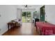 Bright living room with a ceiling fan and sliding glass door to the backyard at 6718 Pueblo Ln, Charlotte, NC 28227