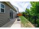 A patio and green lawn offers a relaxing backyard oasis, with wood and metal fencing for privacy at 679 Cape Fear St, Fort Mill, SC 29715