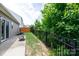 A backyard featuring a patio, iron fence, lush trees and green lawn, perfect for outdoor enjoyment at 679 Cape Fear St, Fort Mill, SC 29715