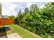 The backyard offers a lush green space bordered by a wood and metal fence at 679 Cape Fear St, Fort Mill, SC 29715