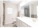 This bathroom features double sinks, a large mirror, and a tiled shower with glass door at 679 Cape Fear St, Fort Mill, SC 29715