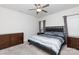 This bedroom features a ceiling fan, carpeted floors, and a queen-sized bed with gray bedding at 679 Cape Fear St, Fort Mill, SC 29715