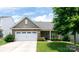 Charming home featuring stone accents, a two-car garage, well-manicured lawn and inviting entrance at 679 Cape Fear St, Fort Mill, SC 29715
