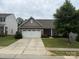 Charming single-story home featuring stone accents, a two-car garage, and a well-manicured lawn at 679 Cape Fear St, Fort Mill, SC 29715