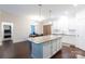Open concept kitchen with island, granite countertops, and adjoining dining area at 679 Cape Fear St, Fort Mill, SC 29715