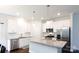 Bright kitchen with stainless steel appliances, granite countertops, and white cabinetry at 679 Cape Fear St, Fort Mill, SC 29715