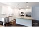 Modern kitchen featuring an island, stainless steel appliances, and sleek white cabinets at 679 Cape Fear St, Fort Mill, SC 29715