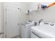 Laundry room features a modern washer and dryer with shelving at 679 Cape Fear St, Fort Mill, SC 29715